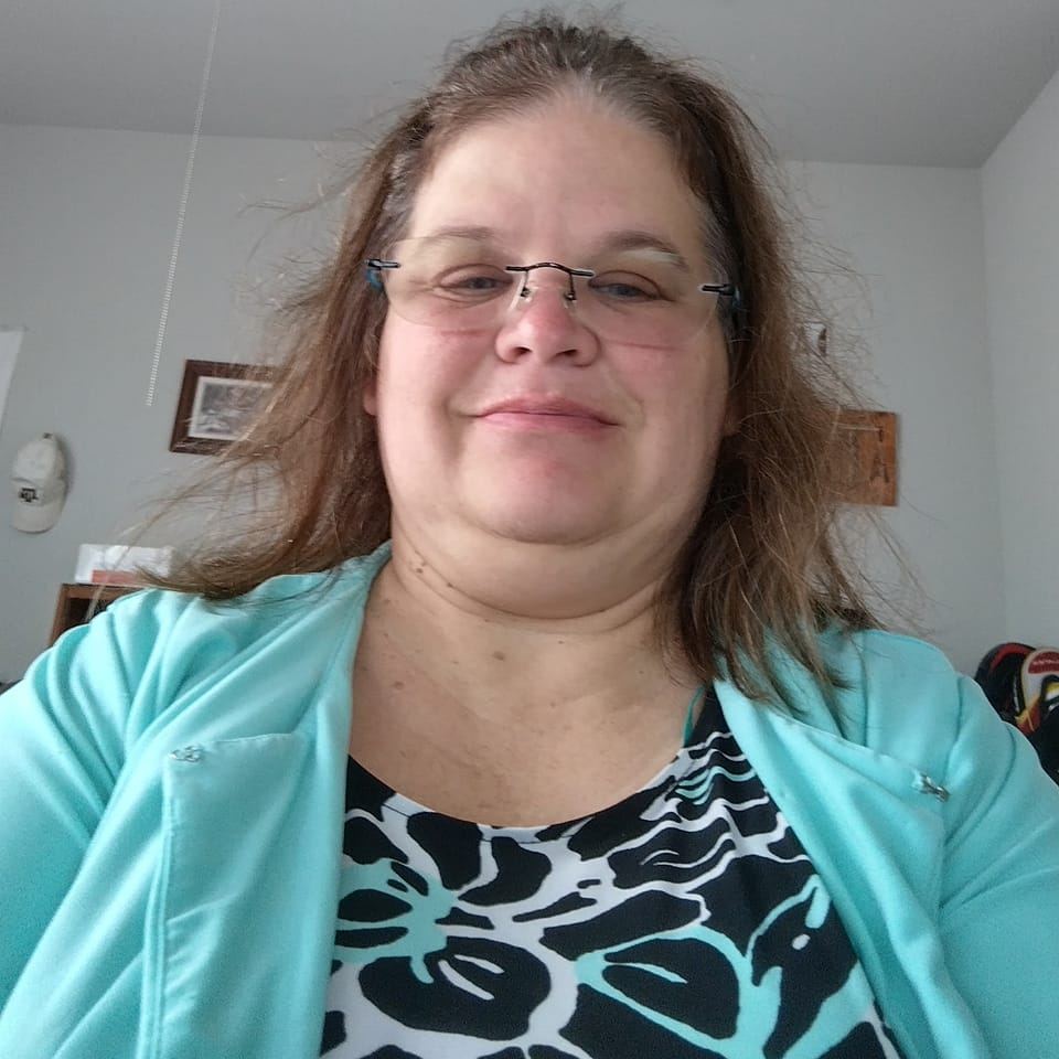 Christine smiling with yarn